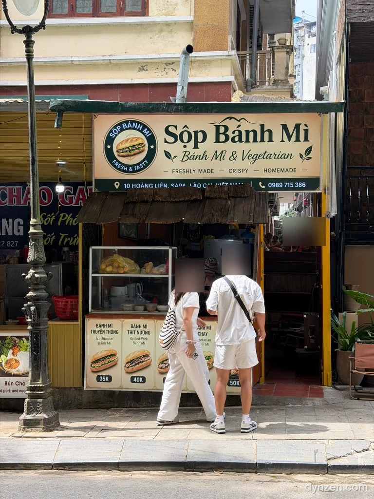 The front of Sộp Bánh Mì, a banh mi menu board and a glass display case under a ‘Bánh Mì & Vegetarian’ sign