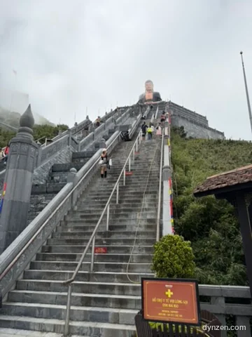 People going up and down the long stone stairs leading to the Great Buddha
