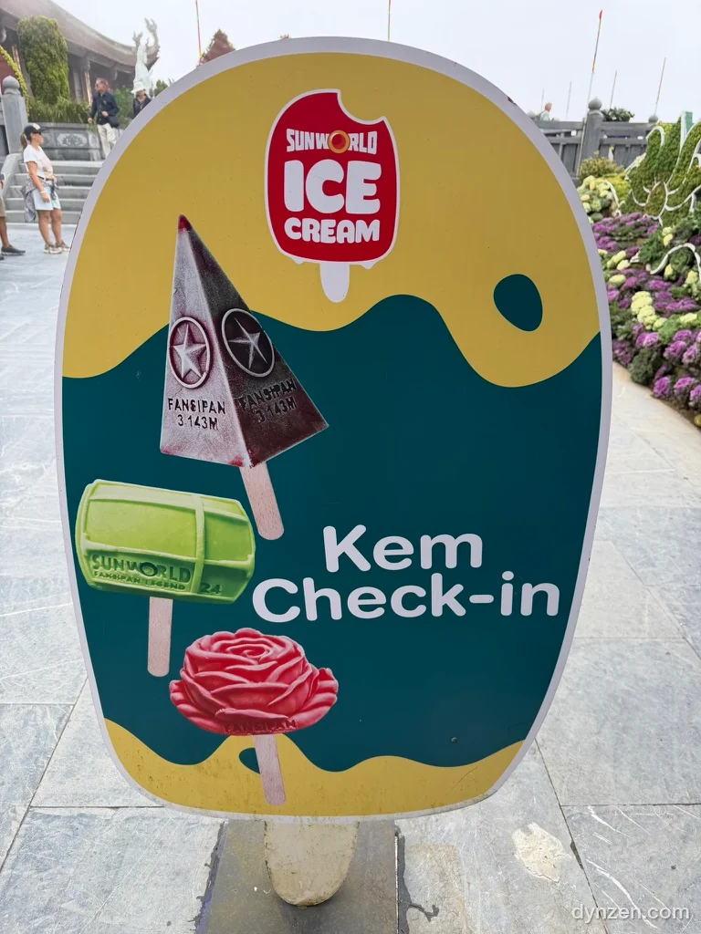 A Sun World ice cream sign with the words ‘Kem Check-in’ and pictures of ice cream shaped like the summit marker and a rose