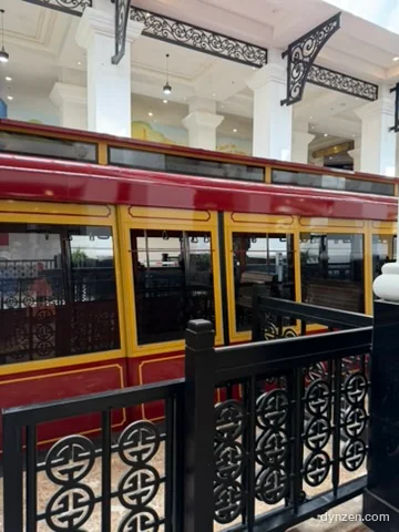 The red Muong Hoa funicular at the Sapa Station platform, with yellow window frames and black metal railings