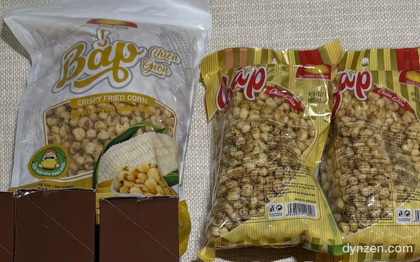 Crispy fried corn snack in one large white bag and two small yellow bags