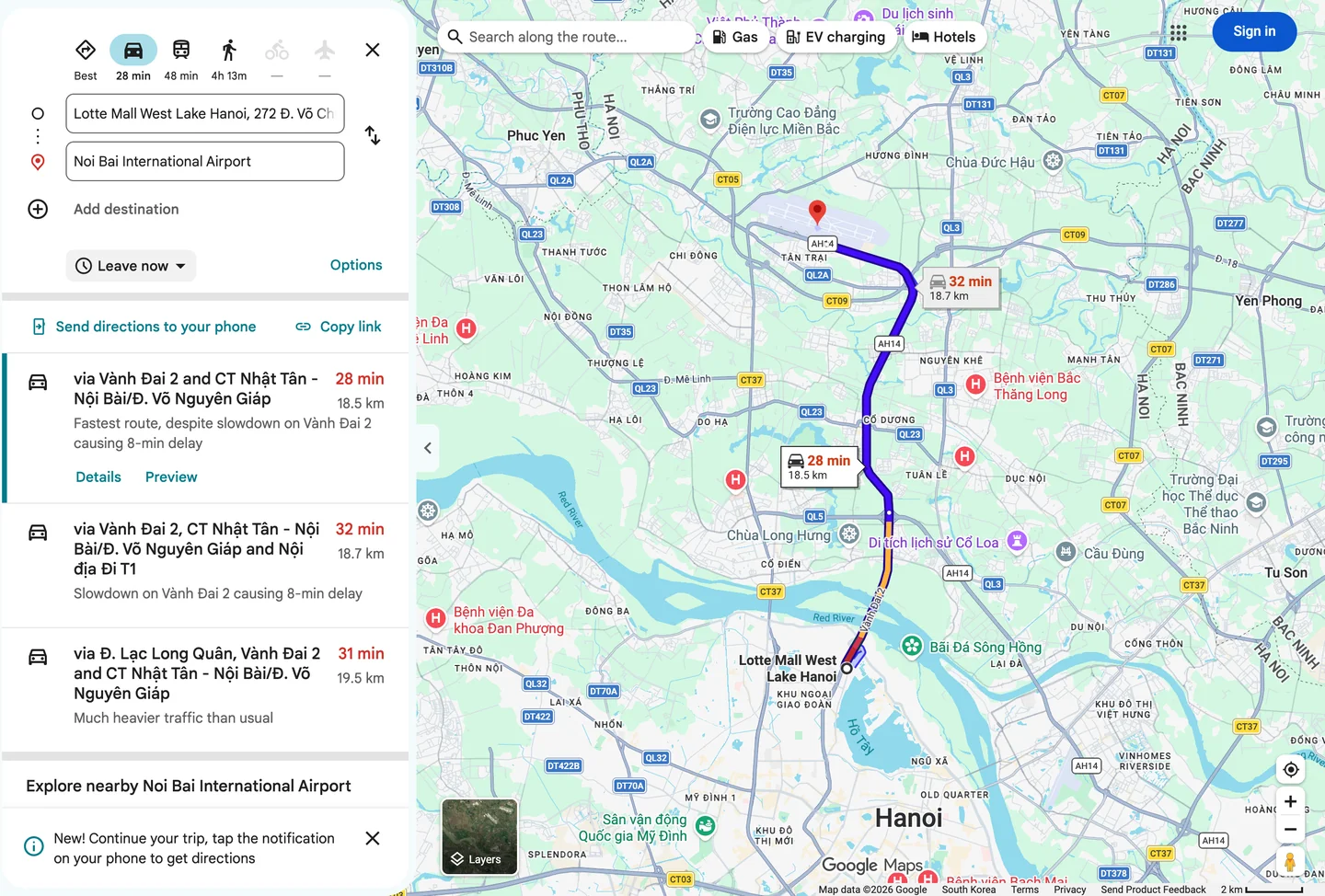 Google Maps route, a purple line from Lotte Mall West Lake across the Nhat Tan Bridge to Noi Bai International Airport in the north, 18.5km